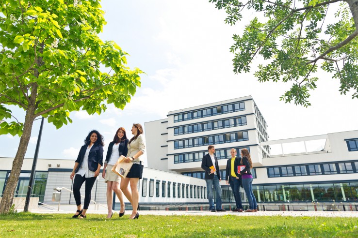 students outdoors on university campus in summer