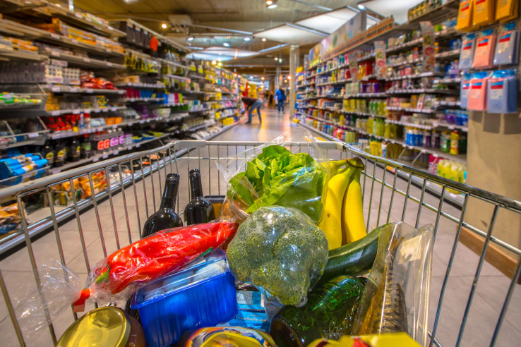 Supermarket cart filled up with products