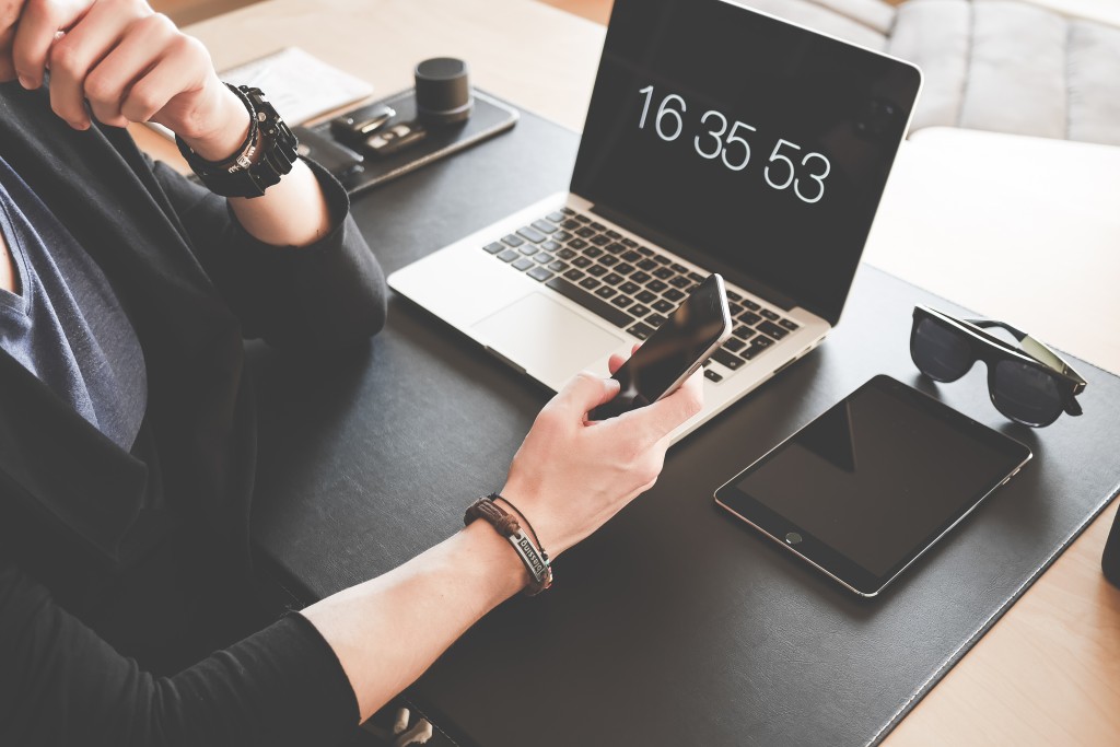 man-checking-his-iphone-working-at-home-office-picjumbo-com