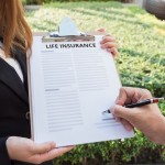 Man signing the life insurance contract.