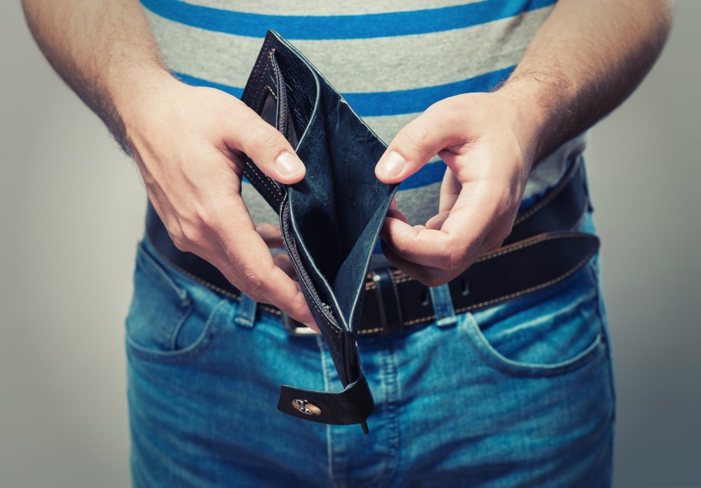 Bankruptcy - Business Person holding an empty wallet