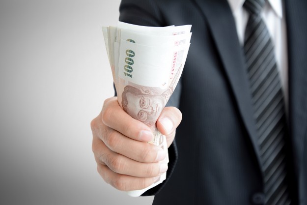 Businessman hand grabbing money, Thai Baht (THB)