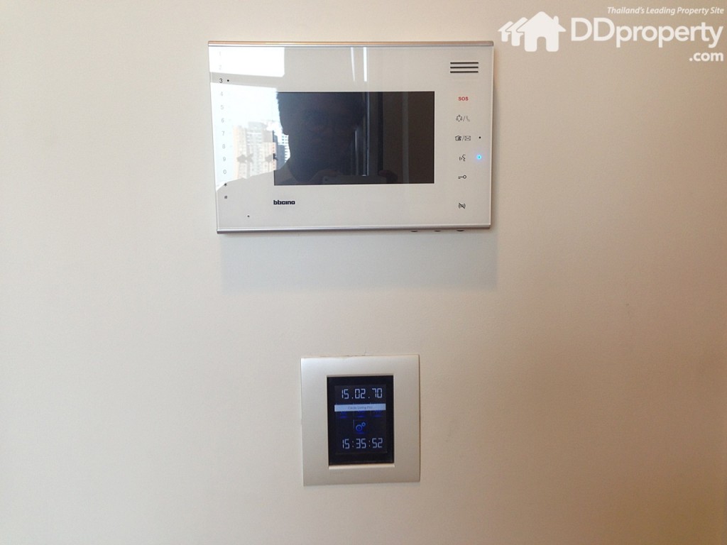 An air-conditioning control panel and security-check monitor