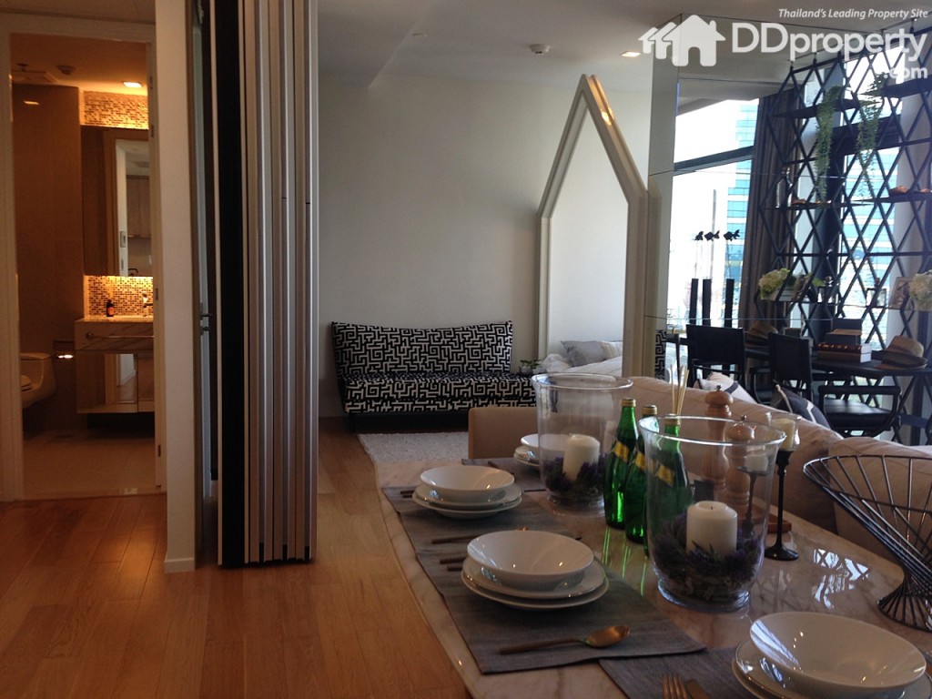 A partition dividing living-room area and small bedroom