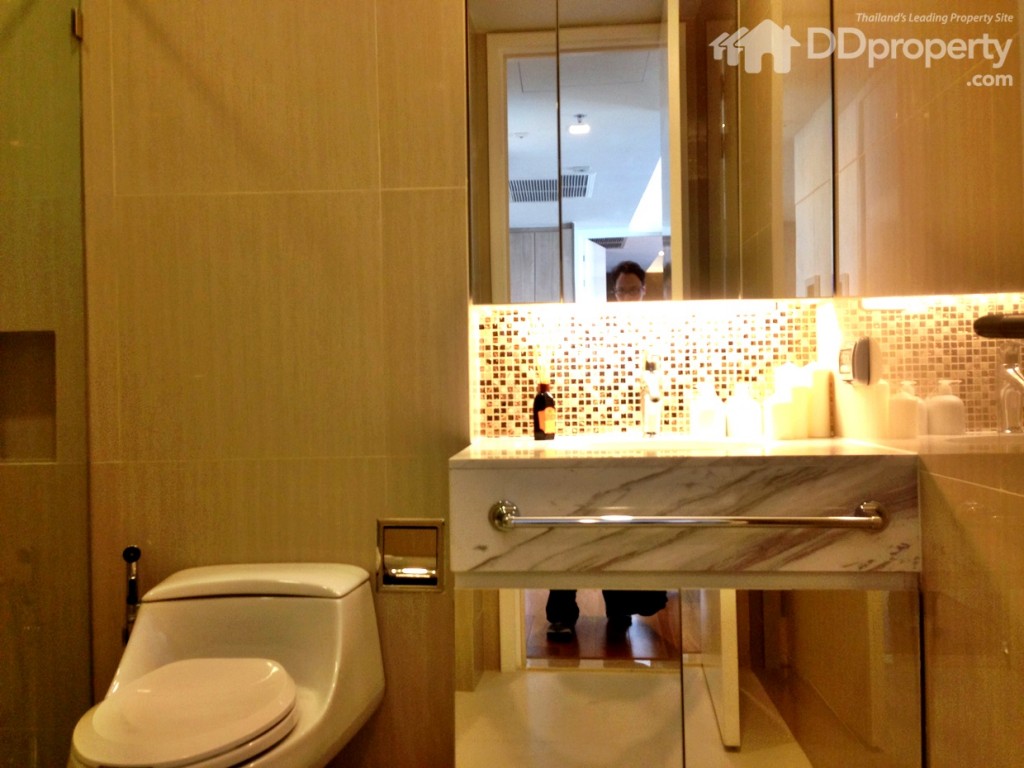 อ่างล้างมือยี่ห้อโคห์เลอร์ มีชั้นวางของตู้กระจกเงาเหนืออ่างล้างมือ