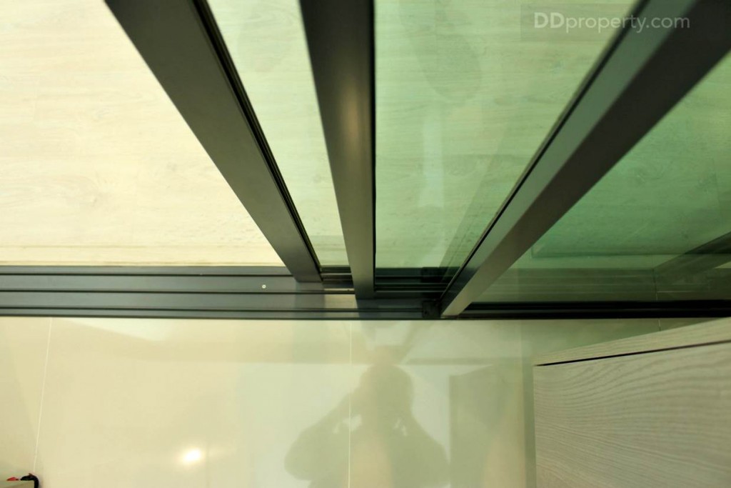 พื้นที่ของห้องครัวเป็นประตูบานเลื่อนแบบ 3 ตอนขอบอะลูมิเนียม Power Coat สีเทา พร้อมกระจกใสเขียว ช่วยให้ห้องสว่าง และกันกลิ่นอาหาร