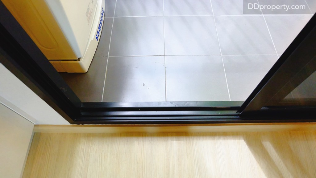 พื้นบริเวณระเบียงปูด้วยเซรามิกขนาด 30x30 ซม. ประตูเป็นกระจกบานเลื่อน