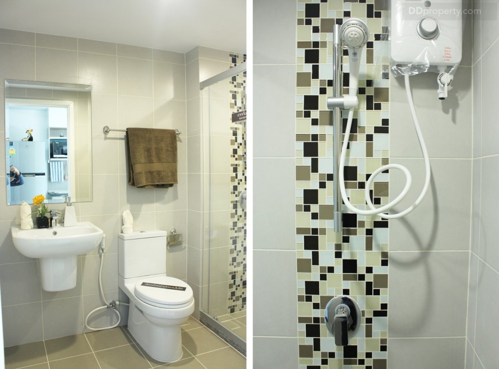 ผนังห้องน้ำปูกระเบื้องมาให้จนจรดเพดาน ที่เพดานติดไฟดาวน์ไลท์มาให้ พร้อมพัดลมดูดอากาศ และเครื่องทำน้ำอุ่นก็ใหม่มาเช่นกัน