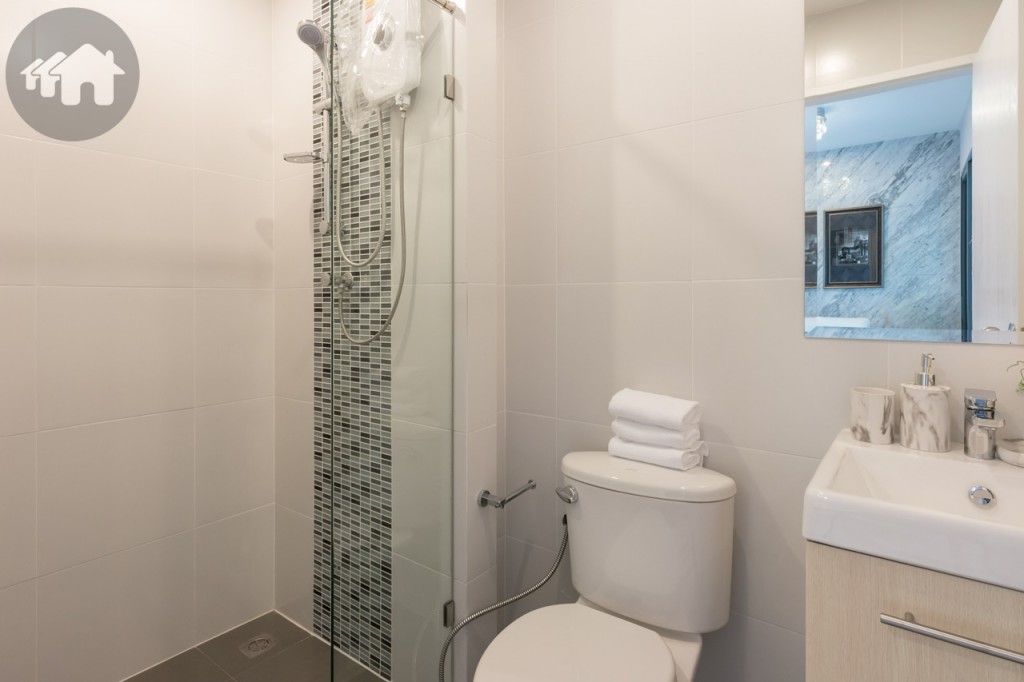 ติดกันเป็นห้องน้ำ ดร็อปพื้นต่ำจากห้องนั่งเล่นประมาณ 2 เซนติเมตร พร้อมสุขภัณฑ์ครบครัน พื้นและผนังปูกระเบื้องแกรนิตโต้ขนาด 40x40 เซนติเมตร