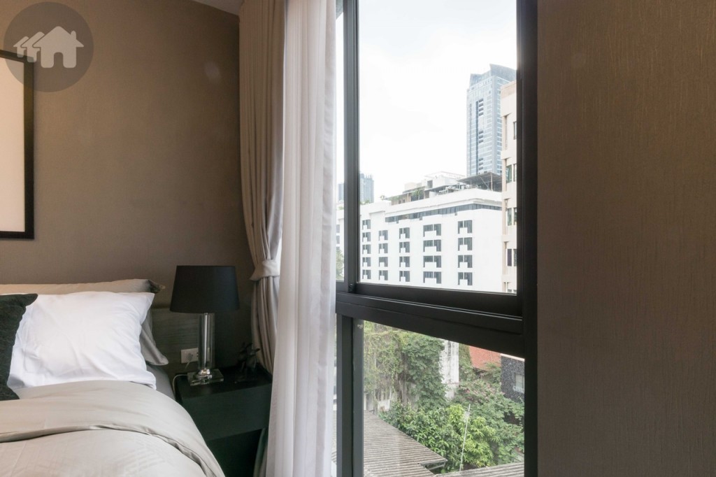On the other side is a little nightstand, and a sliding window distant around 60 cm. from the bed