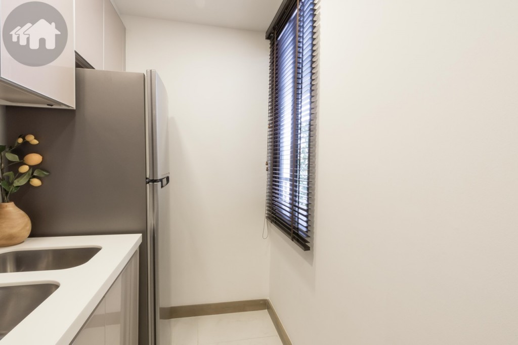 A window blind opposite the Samsung-branded refrigerator helps brighten the kitchen with natural light