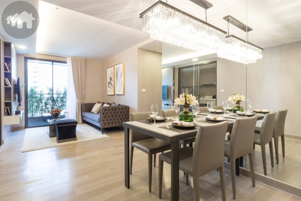 A splendid living space comprising of four-seater dining table and a stately living room