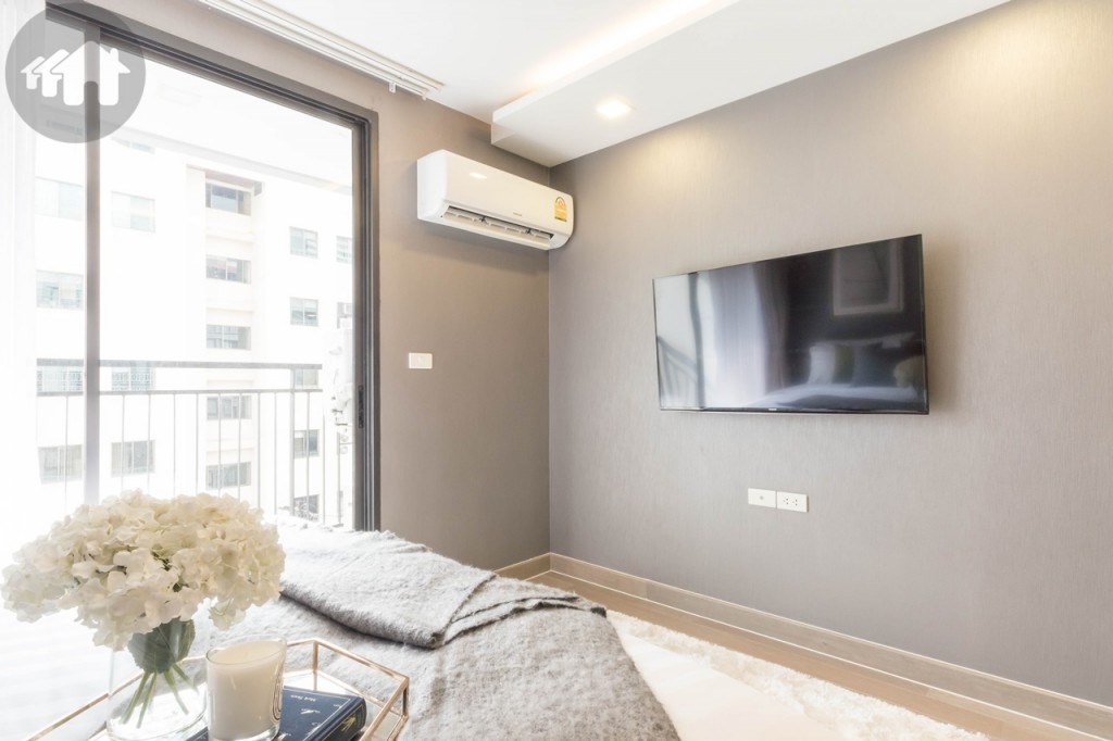 A wall mounted TV is set with 1.60-metre distance from the bed