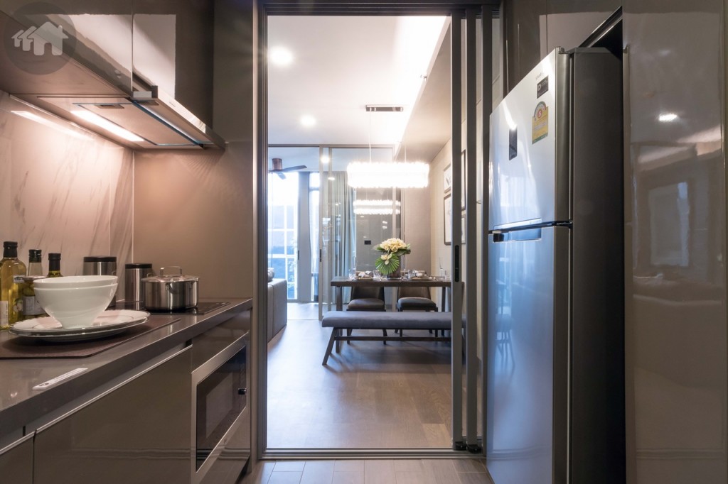 ย้อนกลับมาที่ห้องครัวเชื่อมต่อกับพื้นที่รับประทานอาหารและห้องนั่งเล่น กั้นเป็นสัดส่วนด้วยประตูกระจกบานเลื่อนแบบ 3 ตอน ป้องกันกลิ่นรบกวนภายในห้อง