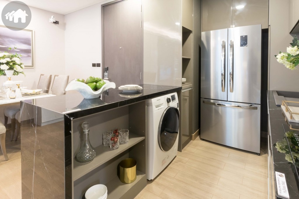 เคาน์เตอร์เตรียมอาหารด้านล่างตกแต่งเป็นชั้นวางเครื่องครัว และมีช่องสำหรับวางเครื่องซักผ้า