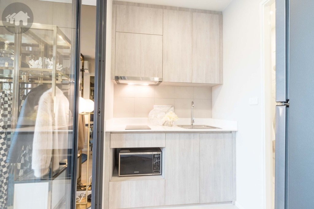 ห้องครัว พื้นปูกระเบื้องขนาด 30x30 เซนติเมตร มาพร้อมตู้ครัวบิลท์อินบน-ล่าง ผนังด้านหลังตู้ครัวปูกระเบื้องขนาด 30x30 เซนติเมตร 