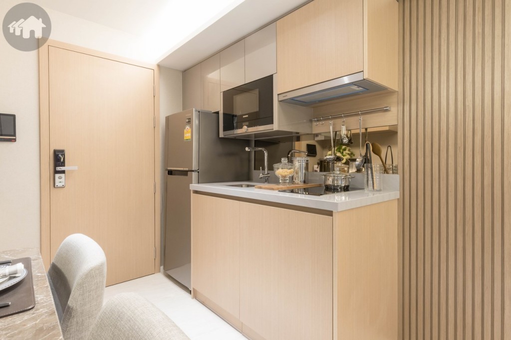 ตรงข้ามเป็นส่วนห้องครัว ตู้บิลท์อินบน-ล่าง ด้านข้างมีช่องสำหรับวางตู้เย็นกว้างประมาณ 65 เซนติเมตร วางตู้เย็นขนาด 8.4 คิวได้สบายๆ