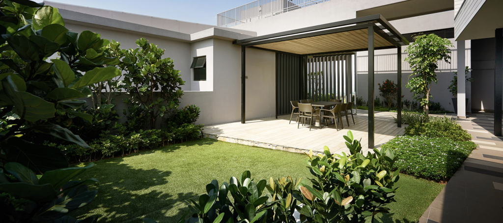 The eye-catching architecture features lots of glass and linear lines, softened with pockets of green foliage.