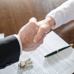 Estate agent shaking hands with his customer