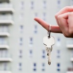 A real estate agent holding keys to a new apartment in her hands.