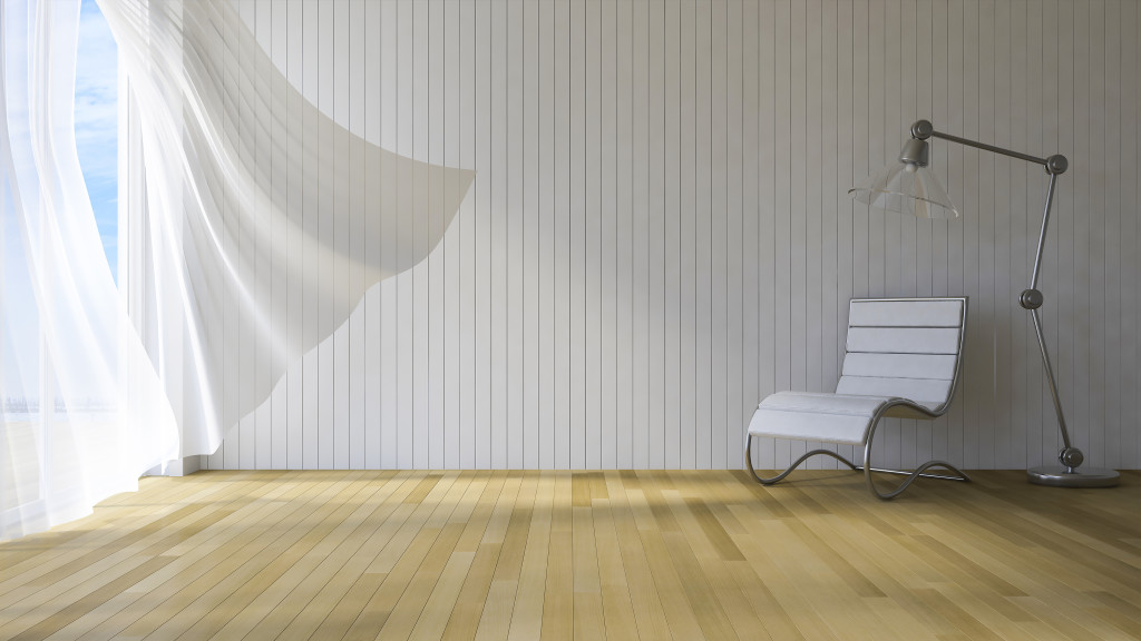 3ds rendered image of seaside room , White fabric curtains being blown by wind from the sea, wooden wall and floor, Chair and lamp