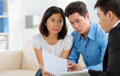 A loan officer going through a loan document with home loan applicants