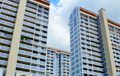 White and light-blue HDB flats in the day