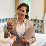 A property agent handing keys to her client