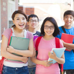 smiling students  standing together at campus