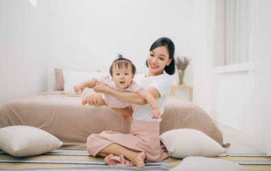 portrait of asian mother and baby relaxing in the room