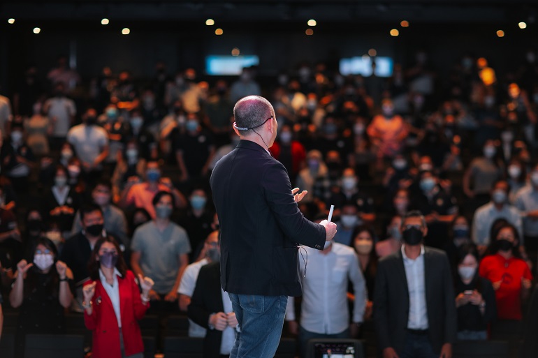 Mr Lim Yong Hock, KEO of PropNex SIngapore addressing the crowd as he stood on stage to  an excited group of attendees